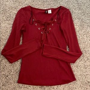 Red long sleeve shirt with adjustable ties.